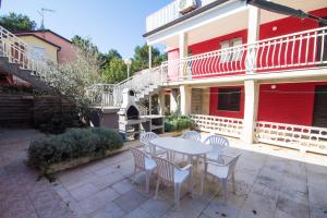 a patio with a table and chairs in front of a building at Private Apartments Stella Maris in Umag