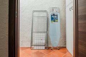 a surfboard leaning against a wall next to a door at Casa P - Relax nel verde a Ezzi Minori in Cuile Ezi Mannu +19 photos