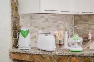 a kitchen counter with appliances on a counter top at Casa P - Relax nel verde a Ezzi Minori in Cuile Ezi Mannu