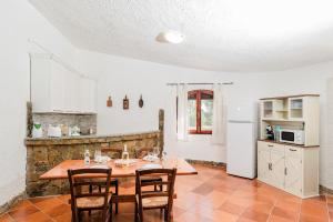 a kitchen and dining room with a table and chairs at Casa P - Relax nel verde a Ezzi Minori in Cuile Ezi Mannu