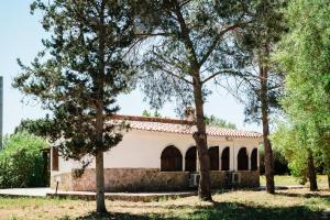 an old building with trees in front of it at Casa P - Relax nel verde a Ezzi Minori in Cuile Ezi Mannu