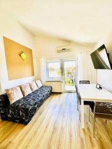 a living room with a couch and a table at Maja - Apartment 1 in Funtana +22 photos