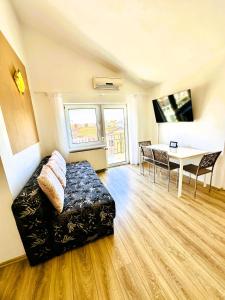 a living room with a couch and a table at Maja - Apartment 1 in Funtana