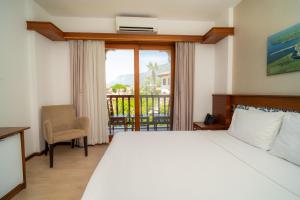 a hotel room with a bed and a balcony at Hotel Lotus Spa&Sport Akyaka in Akyaka +43 photos
