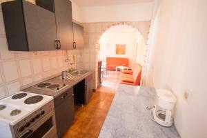 a kitchen with a sink and a stove top oven at Private Apartments Stella Maris in Umag
