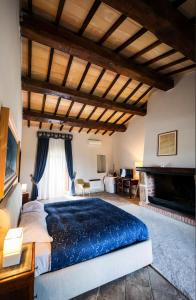 a bedroom with a large bed and a fireplace at Agriturismo Cerrosughero in Canino +181 photos