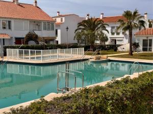 a swimming pool in front of some houses at Casa Feliz in Torrox Costa