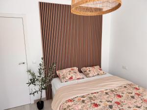 a bed with two pillows on it in a room at Casa Feliz in Torrox Costa +18 photos
