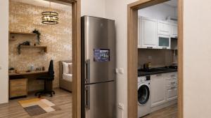 a kitchen with a stainless steel refrigerator and a desk at Studio Luxury Center in Iaşi
