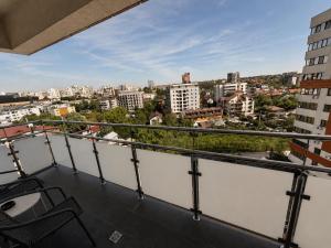 a balcony with chairs and a view of a city at Studio Luxury Center in Iaşi +4 photos