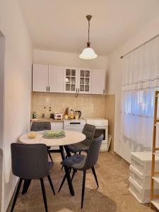 a kitchen with a table and chairs in a room at Apartment Guberinic in Tivat