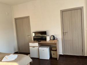 a room with a desk with a bed and a table at Center City Stay 2 in Skopje