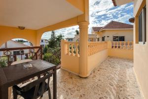 a balcony of a house with a table at Villa Baya in Bayahibe
