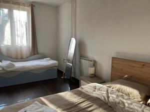 a bedroom with two beds and a window at Center City Stay 2 in Skopje