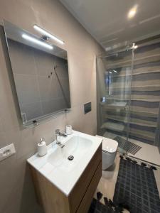 a bathroom with a sink and a shower and a toilet at Paloma in Santa Flavia +21 photos