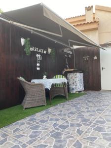 a tent with a table and chairs in a yard at Cottage in Ciudad Quesada in Ciudad Quesada