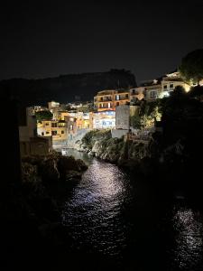 a view of a river at night with buildings at Paloma in Santa Flavia