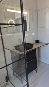 a bathroom with a sink and a mirror at Apartman Bartimej 3 in Bobrów +33 photos
