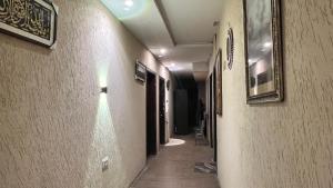 a hallway of a building with paintings on the walls at Adams Lodge F-7 in Islamabad +13 photos