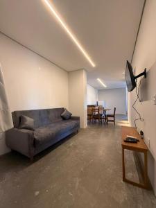 a living room with a couch and a table at Pitaya Apart Hotel in Garopaba