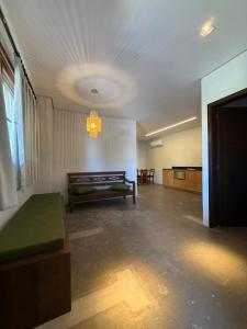 an empty room with a bed and a chandelier at Pitaya Apart Hotel in Garopaba +46 photos