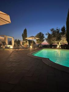a swimming pool in a yard at night at Agriturismo Cerrosughero in Canino