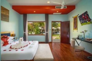 a bedroom with a large bed with a red ceiling at Habana Angkor Resort in Siem Reap +43 photos