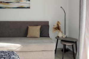 a living room with a couch and a table with a lamp at Scalo del Mare Apartment in Keramoti