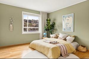 a bedroom with a large bed and a window at The Nordic Escape - Oceanview - Hetlevik in Askøy