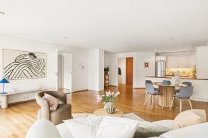 a living room with a couch and a table at The Nordic Escape - Oceanview - Hetlevik in Askøy +15 photos