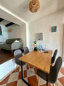 a living room with a wooden table and chairs at Apartment Memories II in Baška +8 photos