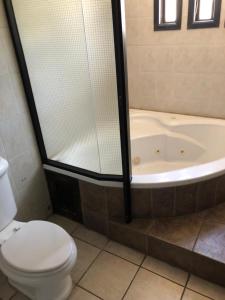 a bathroom with a toilet and a bath tub at Saray-ı Hümayun in Santa Rosita