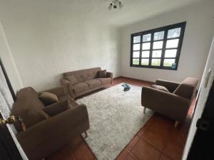 a living room with couches and a window at Saray-ı Hümayun in Santa Rosita