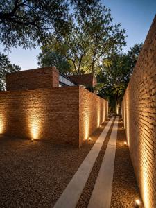 a brick wall with lights on the side of it at Makham Villa River Kwai in Kanchanaburi City