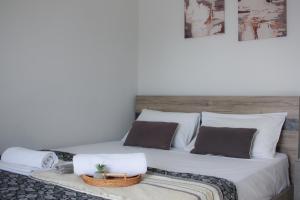 a bedroom with a large white bed with two pillows at Scalo del Mare Apartment in Keramoti