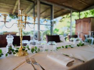 a table with a white table cloth and silverware on it at Agriturismo Cerrosughero in Canino