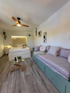 a bedroom with two beds and a ceiling fan at La Petite Finca in Elche +31 photos