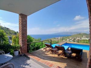 a patio with a view of the ocean from a house at Grand Seaview Apartments in Ksamil