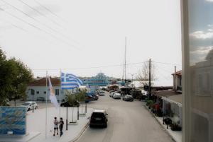a city street with a cruise ship in the distance at Scalo del Mare Apartment in Keramoti