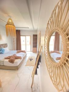 a bedroom with two beds and a large mirror at KAZA Wave Surf camp in Imsouane