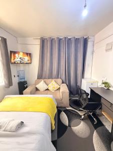 a living room with two beds and a couch at Ruiru Cozy stays in Ruiru