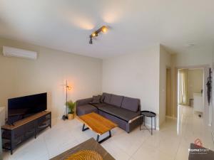 a living room with a couch and a table at MOS luxury project by Homebrain in Alexandroupoli