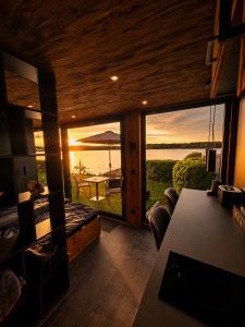 a living room with a view of the water at Seechalet Kranich in Roding