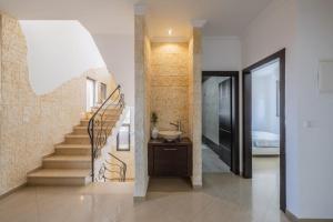 a bathroom with a staircase with a sink and a stair case at וילה הריביירה in Netanya +70 photos