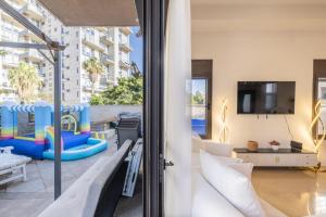 a room with a view of a living room with a slide at וילה הריביירה in Netanya