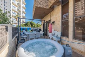 a bath tub on the balcony of a building at וילה הריביירה in Netanya