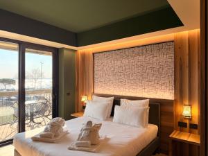 a bedroom with a bed with towels on it at Alevic Hotel Sirmione in Sirmione +182 photos