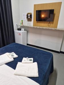 a hotel room with a bed with towels on it at 2204 Chácara Pousada CadClub Quarto Suíte Para Casal in Sao Jose do Rio Preto