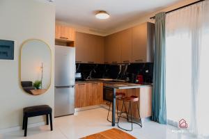 a kitchen with wooden cabinets and a white refrigerator at MOS luxury project by Homebrain in Alexandroupoli