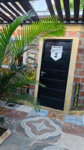 a black garage door with a sign on it at Hostel y Motoposada Sudaka in Garupá